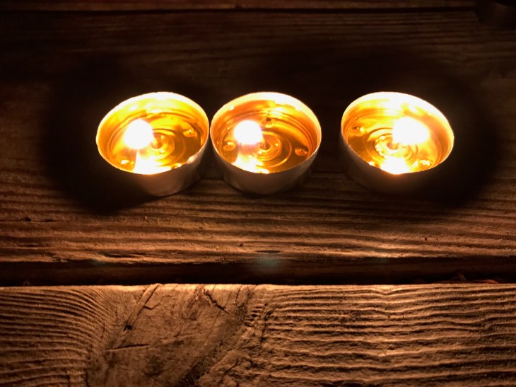 3 tea candles on wooden table